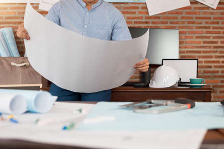 Engineer or Architect is reading paper blueprint project plan. Civil engineering, Architect concept.の写真素材