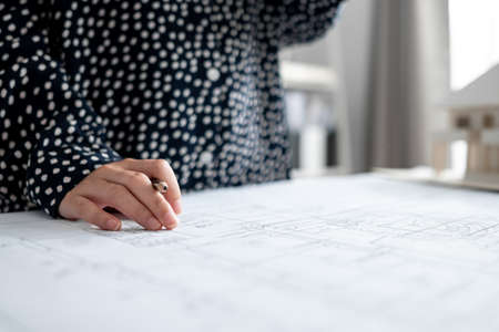Close up Architect or Engineer hand preparing sketch the drawing construction building.