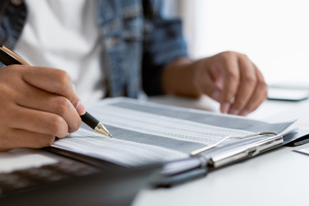 Startup business hand is analyzing financial report or calculating budget own company .
