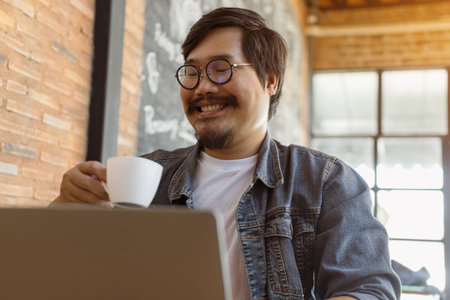 Startup businessman drinking coffee while work. Freelancer is thinking idea or trying to solve a...