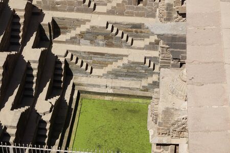 india - rajasthan - jaipur - dausa - chand baori - stepwell - march 28, 2018, moss water appears in stepwellのeditorial素材
