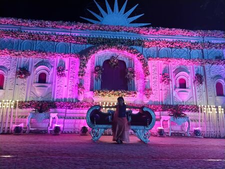 stage is ready for the event, pink and blue light with flower decoration making the place awesomeの写真素材