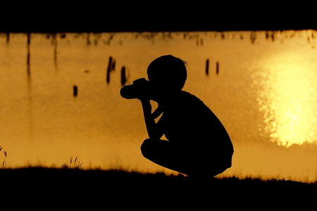 Kid silhouette on the Nature sunsetの写真素材