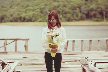 Lifestyle portrait of pretty young hipster woman making photo. Retro photographer.の写真素材