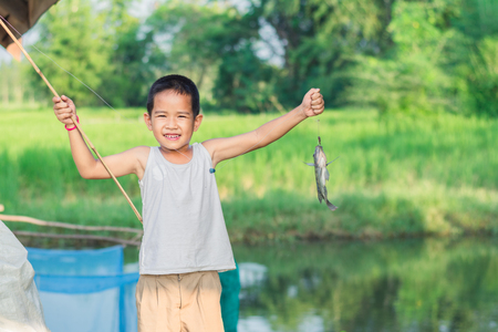 Little Boy Catching a Fish. Kids Fishing.の写真素材