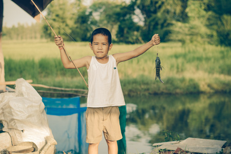 Little Boy Catching a Fish. Kids Fishing.の写真素材