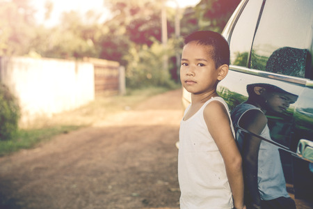 Kid with his old car. Vintage style.の写真素材