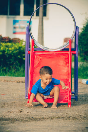 Children playing park. Little baby playing in the park on the  on a sunny day.の写真素材