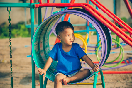 Children playing park. Little baby playing in the park on the  on a sunny day.の写真素材