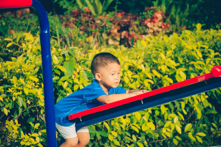 Children playing park. Little baby playing in the park on the  on a sunny day.の写真素材