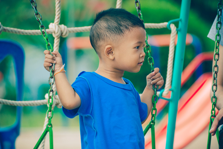Children playing park. Little baby playing in the park on the  on a sunny day.の写真素材