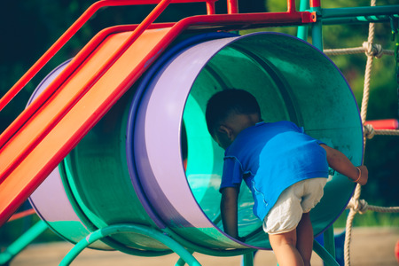 Children playing park. Little baby playing in the park on the  on a sunny day.の写真素材