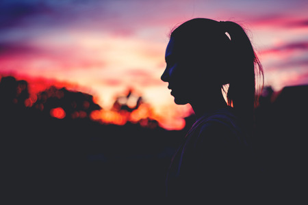Silhouette beautiful woman yoga on sunset. Sunset sky background.の写真素材