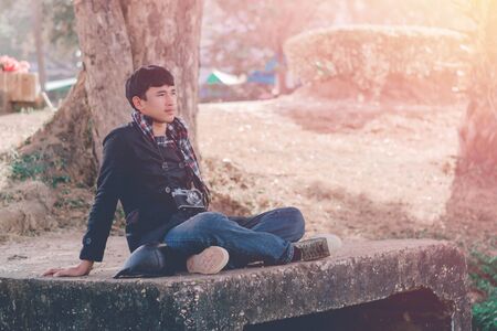Lifestyle portrait of winter man with vintage camera taking photo.の写真素材