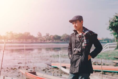 Lifestyle portrait of winter man with vintage camera taking photo.