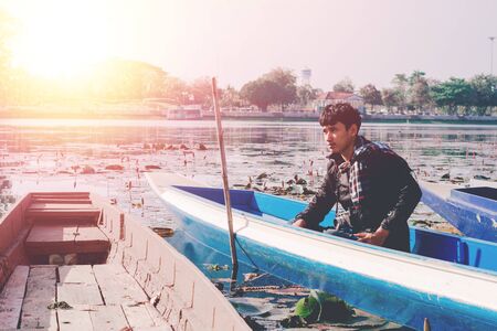Lifestyle portrait of winter man with vintage camera taking photo.の写真素材