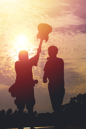silhouette of a young photographer poses teaching model.の写真素材