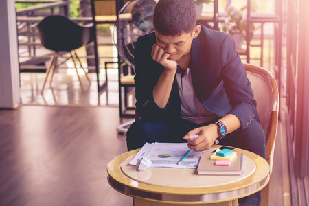 Young businessman failing and serious in office,tired and strain about work.の写真素材
