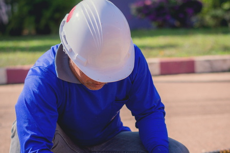Construction worker,Repairing a broken water pipe on the concrete road.の写真素材