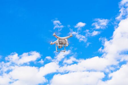 White drone, quadrocopter with photo camera flying concept on the sky.の写真素材