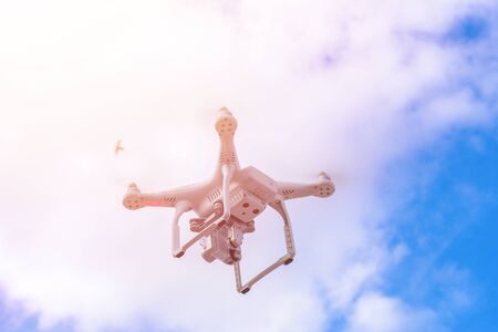 White drone, quadrocopter with photo camera flying concept on the sky.の写真素材