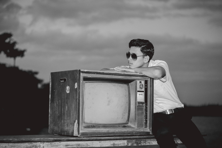 Businessman with vintage tv in nature.の写真素材