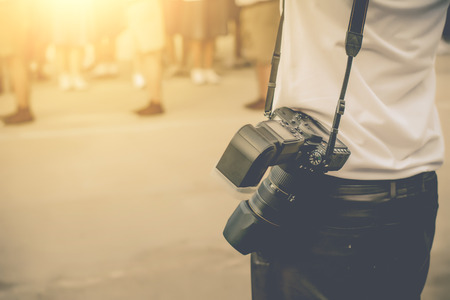 photographer holding camera, close-up.Vintage tone.の写真素材