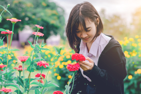 Beautiful girl with flowers in the garden.の写真素材
