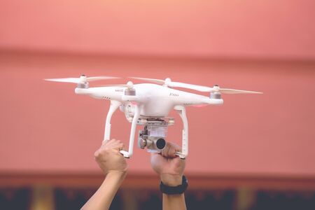 Man holding drone with hand outdoor.の写真素材