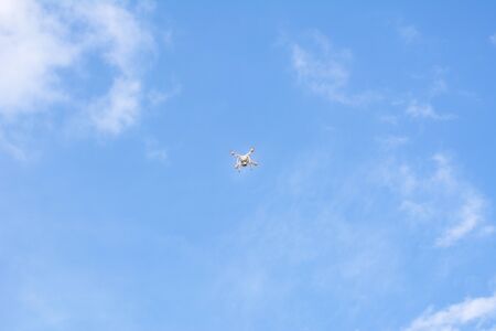 White drone, quadrocopter with photo camera flying concept on the sky.の写真素材