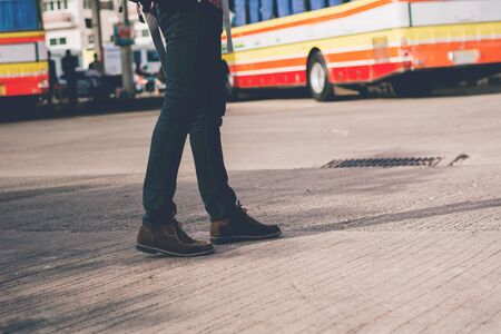 Young man handsome with luggage bag on city street with busy traffic transport looking map, waiting for public busの写真素材