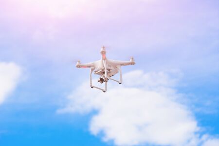 White drone, quadrocopter with photo camera flying concept on the sky.