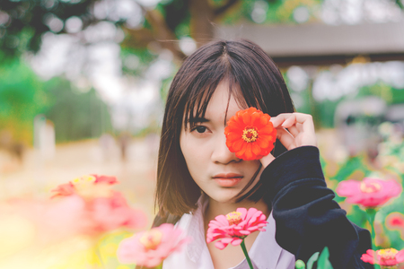 Beautiful girl with flowers in the garden.の写真素材