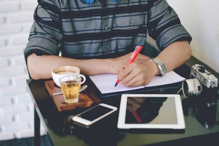 Young business man working with modern devices, digital tablet computer and smartphoneの写真素材