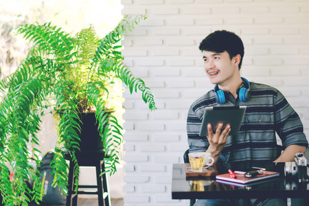 Young business man working with modern devices, digital tablet computer and smartphoneの写真素材