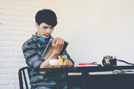 Young business man working with modern devices, digital tablet computer and smartphoneの写真素材