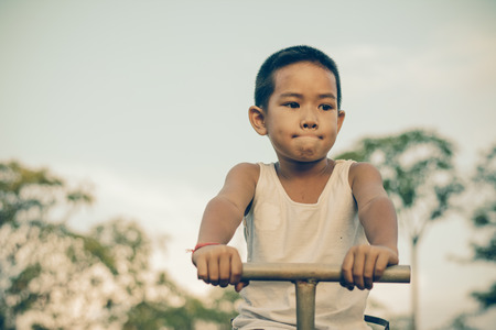 Boy with exercise machines in the parkの写真素材
