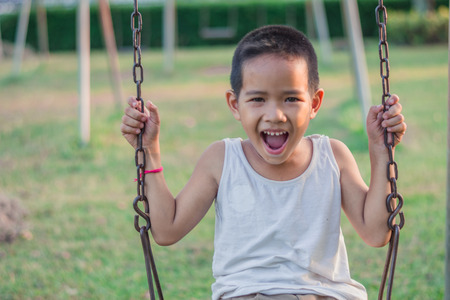 Boy with exercise machines in the parkの写真素材