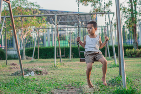 Boy with exercise machines in the parkの写真素材