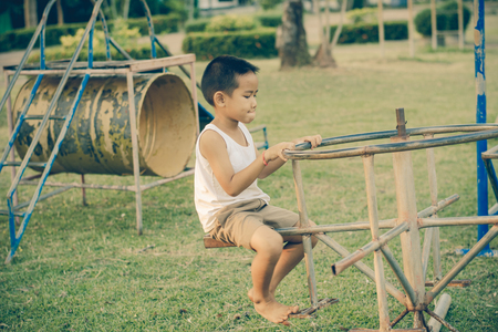 Boy with exercise machines in the parkの写真素材