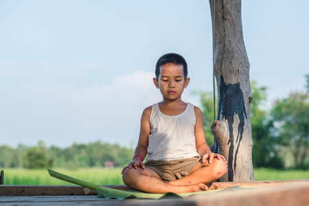 Portrait of boy holding banana leafの写真素材