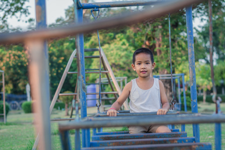 Boy with exercise machines in the parkの写真素材