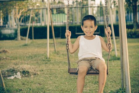 Boy with exercise machines in the parkの写真素材
