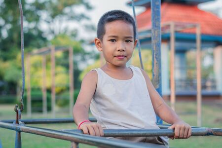 Boy with exercise machines in the parkの写真素材