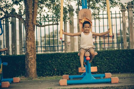 Boy with exercise machines in the park
