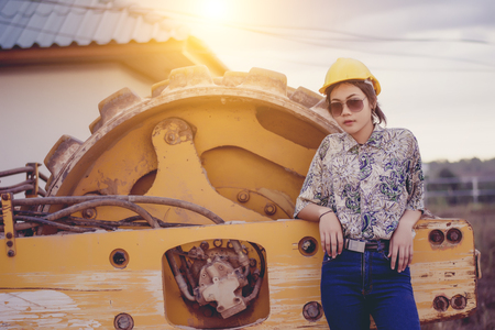 Female engineer with construction worker and steamroller, road construction concept.の写真素材