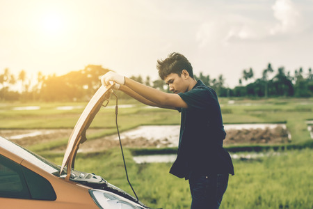 Car mechanic repairing a car engine.の写真素材
