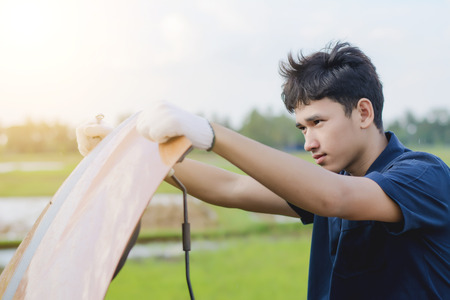 Car mechanic repairing a car engine.の写真素材