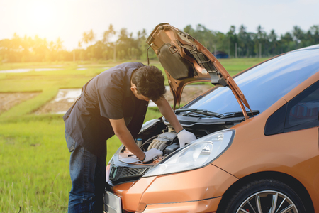 Car mechanic repairing a car engine.の写真素材