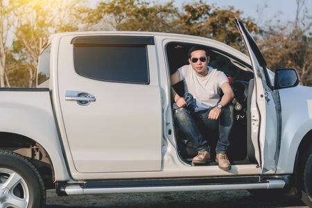 Portrait of young man sitting in car.の写真素材